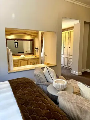 a living room with a couch and a mirror at Franschoek Lermitage Villa Two Bedroom Lake View in Franschhoek