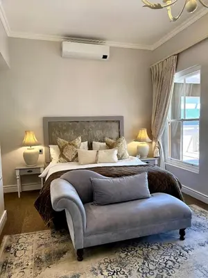 a bedroom with a large bed and a couch at Franschoek Lermitage Villa Two Bedroom Lake View in Franschhoek