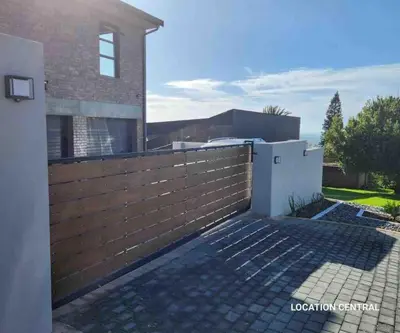 a wooden fence in front of a house at Scenic Mountain & Winelands views, Modern Design in Tygerberg Hills