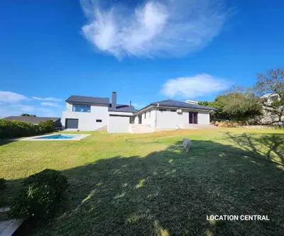 a dog standing in a yard in front of a house at Scenic Mountain & Winelands views, Modern Design in Tygerberg Hills