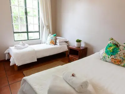 two beds in a room with two windows at The Habit Apartments in Worcester