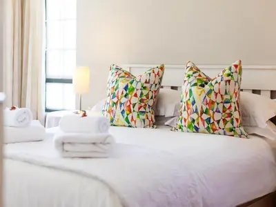a bedroom with a white bed with towels on it at The Habit Apartments in Worcester