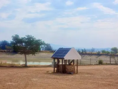 a small building with a blue roof in a field at Val Mor country house in Paarl
