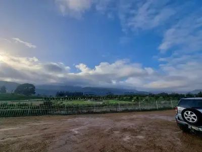 a car parked next to a fence on a dirt field at Val Mor country house in Paarl