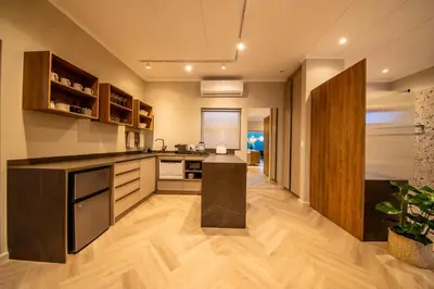 a kitchen with a island in the middle of it at LEO Sky Farm Cottages in Simondium