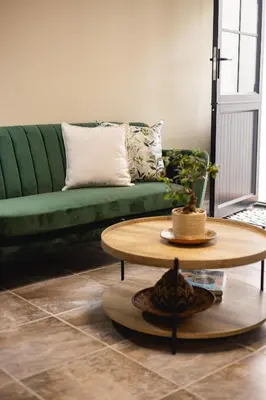 a living room with a green couch and a coffee table at 44 on Mountain Drive in Hermanus