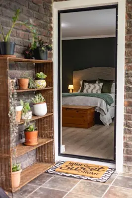 a mirror in front of a bedroom with a bed at 44 on Mountain Drive in Hermanus