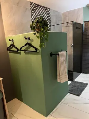 a green door in a bathroom with a plant at Southern Comfort Guest House in Bellville