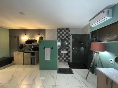 a kitchen with a green refrigerator in a room at Southern Comfort Guest House in Bellville