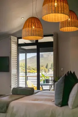 a bedroom with a bed with a view of the mountains at Mountain-View Studio - Hermanus Waterfront Apartments in Hermanus