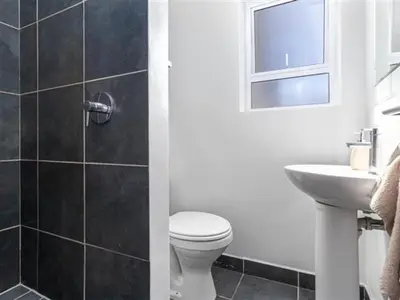 a bathroom with a toilet and a sink at 4 Essex Street Apartment in Cape Town