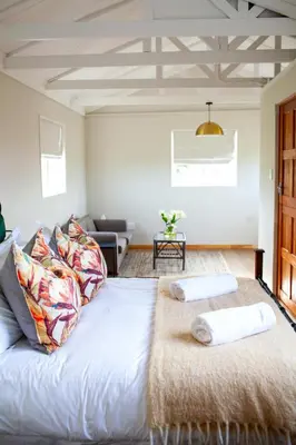 a bedroom with a bed with two towels on it at Kleinhuisie in Hermon