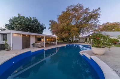a swimming pool in a backyard with a house at LEO Sky Guest House in Simondium