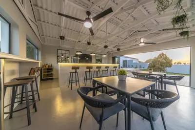 a restaurant with tables and chairs and a bar at LEO Sky Guest House in Simondium