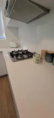 a kitchen with a stove and a white counter top at Blouberg Luxury Studio Apartment in Cape Town