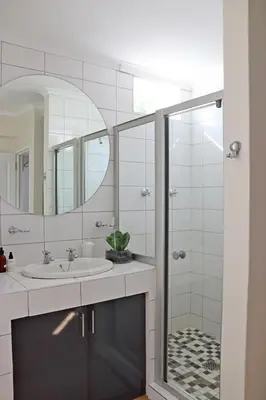 a bathroom with a sink and a shower at Wholeness Accommodation in Hermanus