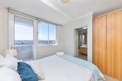 a bedroom with a large bed and a large window at Horizon Bay 206 by HMH in Cape Town