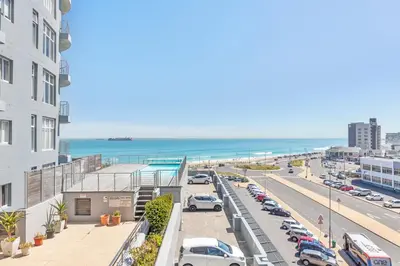 a city street with cars parked in a parking lot at Horizon Bay 206 by HMH in Cape Town