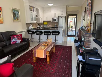 a living room with a couch and a table at Strand cosy 2 bedroom house in Strand