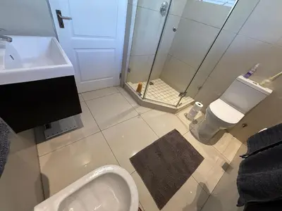 a bathroom with a sink and a toilet and a shower at Strand cosy 2 bedroom house in Strand