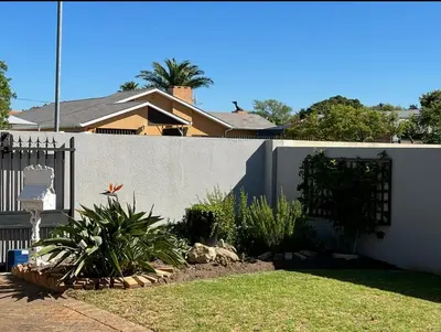a fence in front of a house with plants at Strand cosy 2 bedroom house in Strand