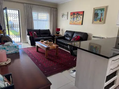 a living room with a couch and a table at Strand cosy 2 bedroom house in Strand