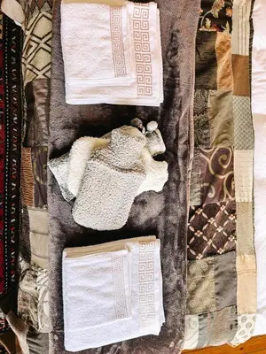 a pile of towels and towels on a table at Dottie's charming cottage two bedroom apartment and workspace in Paarl