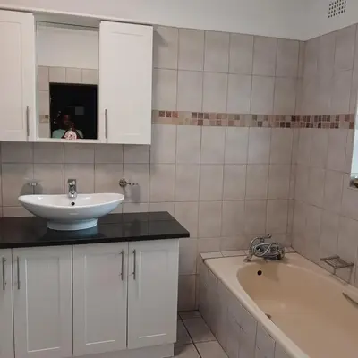 a bathroom with a sink and a bath tub at Tripple S in Bellville