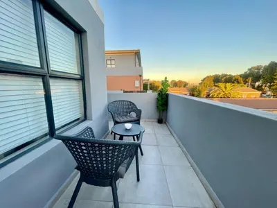 a balcony with two chairs and a table at 18 On 40 North in Cape Town