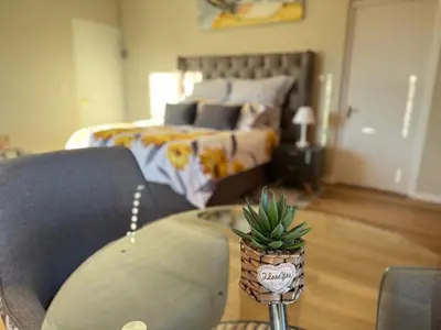 a living room with a bed and a couch at Cape Golf Villa in Cape Town