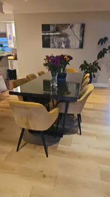 a dining room table and chairs with flowers on it at Cape Golf Villa in Cape Town