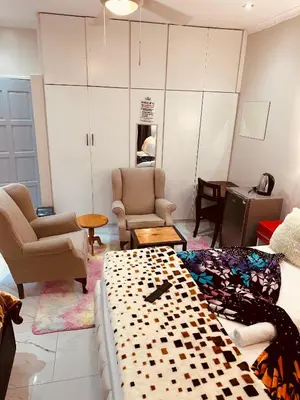 a living room with a couch and chairs and a table at Forest Home Accommodation in De Grendel
