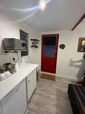a kitchen with a red door and a red door at Rocket Room in Stellenbosch