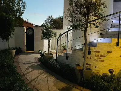 a building with a staircase and a clock on the wall at Rocket Room in Stellenbosch