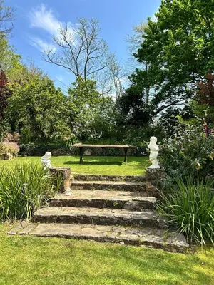 a set of stairs in a park with a bench at Rose Cottage, Elgin Grabouw in Grabouw