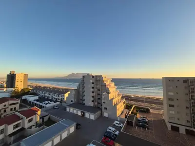 an aerial view of a city with the beach and buildings at Luxurious Ocean View Beachfront Apartment in Cape Town