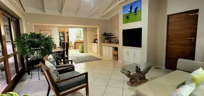 a living room with a couch and a table at Tuinvrede Guesthouse in Welgemoed