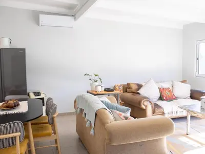a living room with two couches and a tv at The Grey Hound in Strand