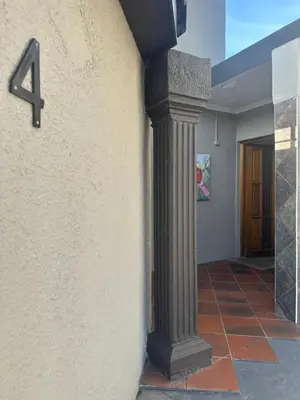 a column on the side of a wall with a number four at Suite Dreams Gorgeous Garden Holiday Home in Panorama