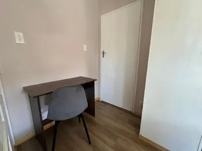 a desk and a chair in a room with a door at Suite Dreams Garden Dream Cottage in Panorama