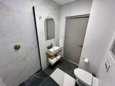 a bathroom with a toilet and a sink and a shower at 34 On The Den in Stellenbosch