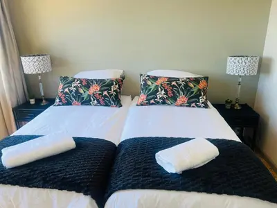 two beds with pillows on them in a room at The House Next Door in Stellenbosch