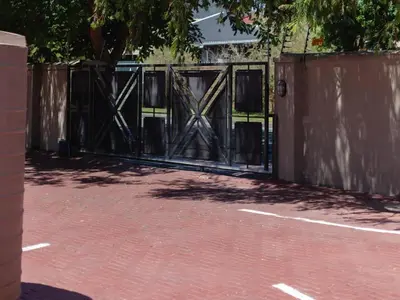 an open gate in a fence with a brick driveway at Julinas Guesthouse in Panorama