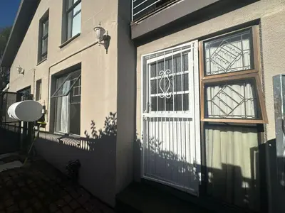 a house with a white gate and a window at Suite Dreams Adorable One Bedroom Apartment in Panorama