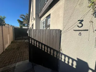 a house with a fence and a gate with the number five at Suite Dreams Adorable One Bedroom Apartment in Panorama