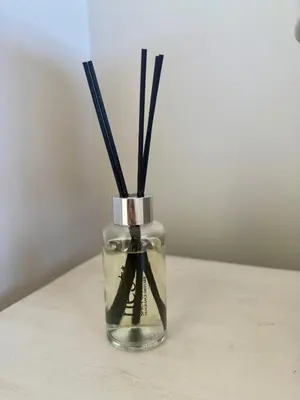 a glass vase with sticks in it on a table at Little Haven in Kenridge