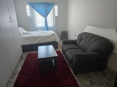 a living room with a couch and a bed at Cozy home away from home in Cape Town