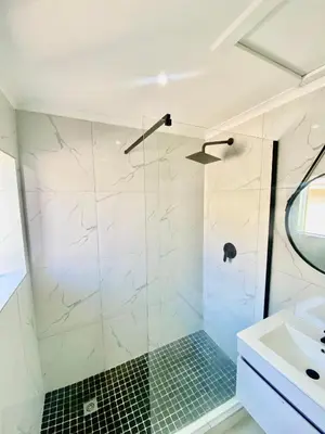a bathroom with a shower and a sink at Chill & Cozy shared apartment with Michael in Cape Town