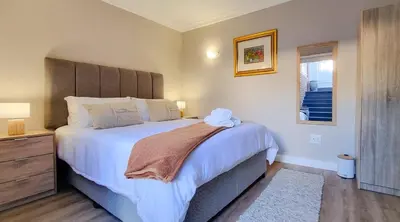 a bedroom with a large bed and a window at La Vita e Bella in Wellington