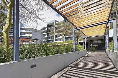 a building with a walkway in front of a building at Chic 1 bedroom apt in Century city in Cape Town